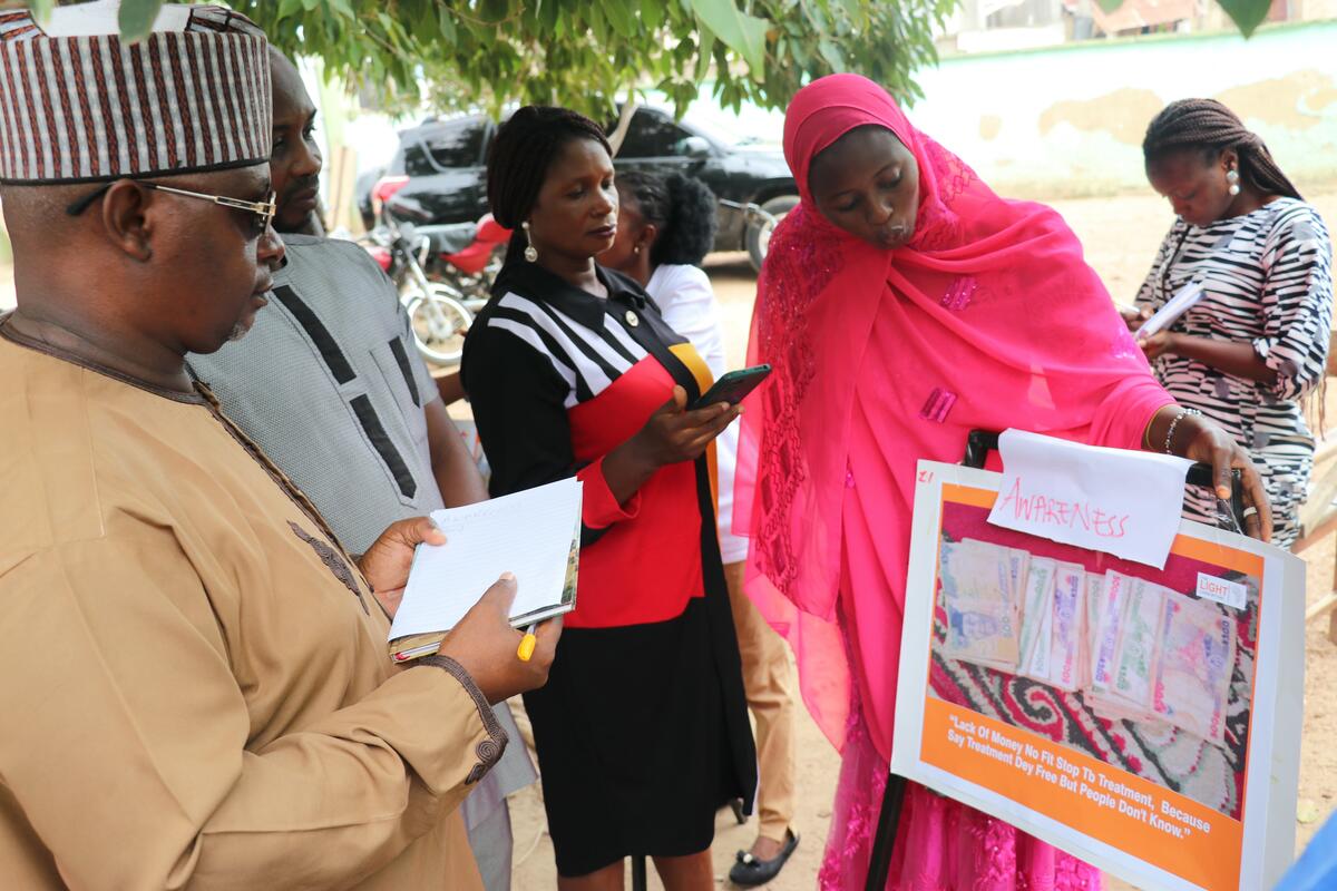 Image 1- One of the participants, Zainab, discussing with the local government representative the meaning and visual narrative of the photo she has taken