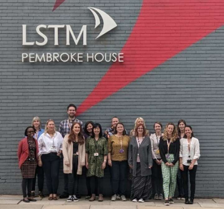 Research support staff in front of Pembroke house